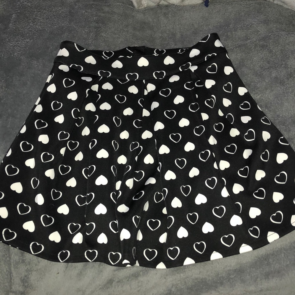 black pleated skirt with white hearts